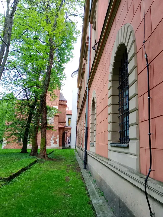 The path along the red-brick façade at Planty beside Pijarska Street