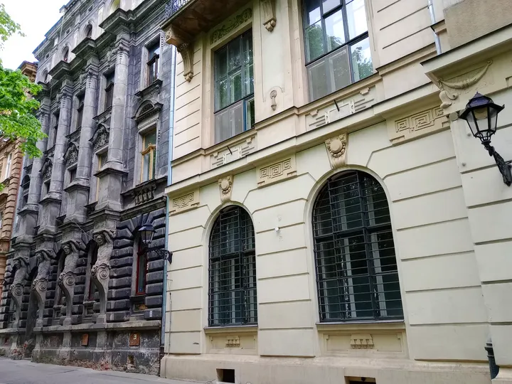 Carved stonework in the street façade at Planty beside Pijarska Street