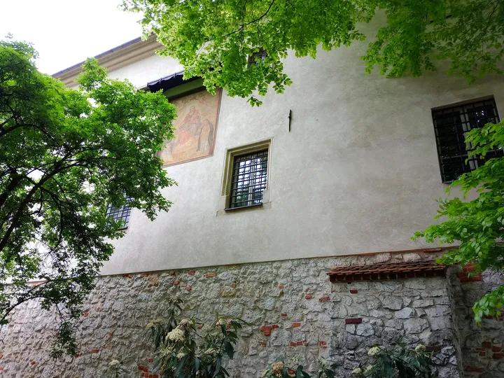 A building above the brick wall at Planty beside Westerplatte Street
