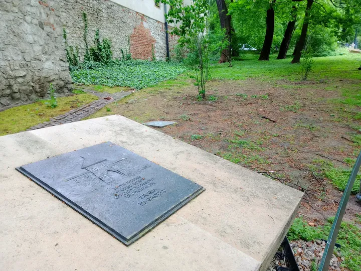 An inscribed slab beside the path at Planty beside Westerplatte Street