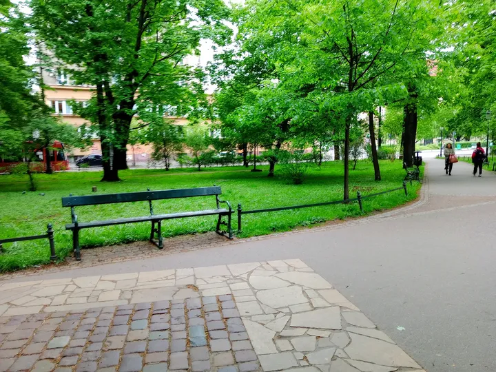 The planted lawn beyond the park path at Planty: Florianka Garden
