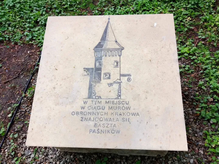 A stone marker with a building outline at Planty: Florianka Garden