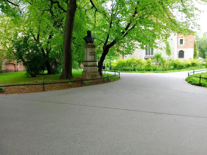 A broad path beneath spring trees at Planty: Station Garden
