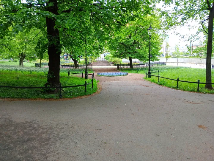 Benches beside a branching park path at Planty: Station Garden