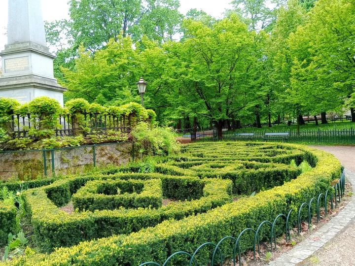 Curved planting beds beside the avenue at Planty: Station Garden