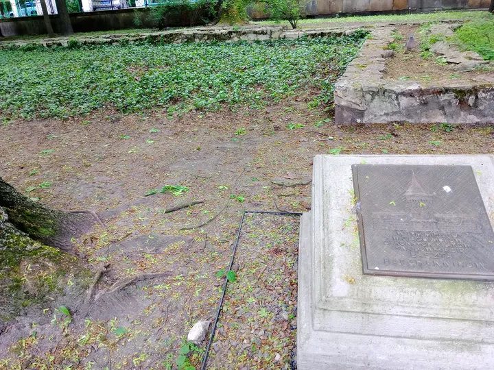 An inscribed stone beside the park path at Planty: Station Garden