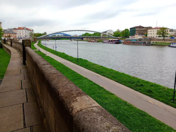 View towards the arched footbridge at Podolski river boulevard