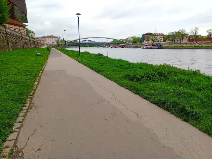 Long paved walk beside the water at Podolski river boulevard