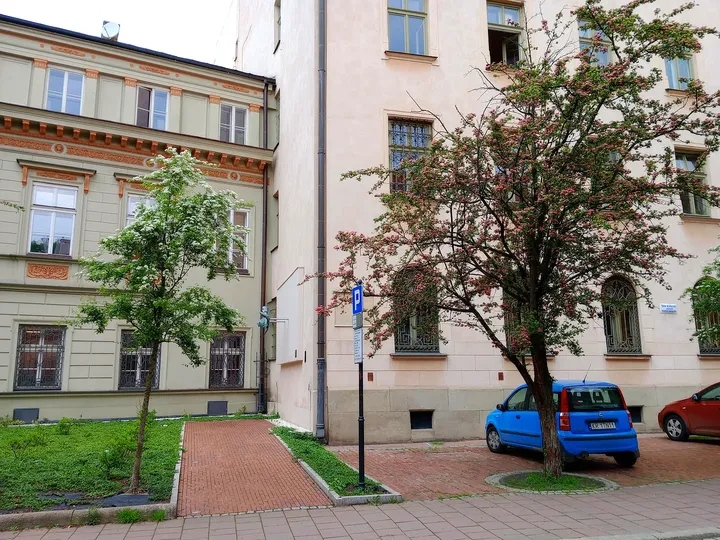 The small planted corner beside the lane at Poselska Street