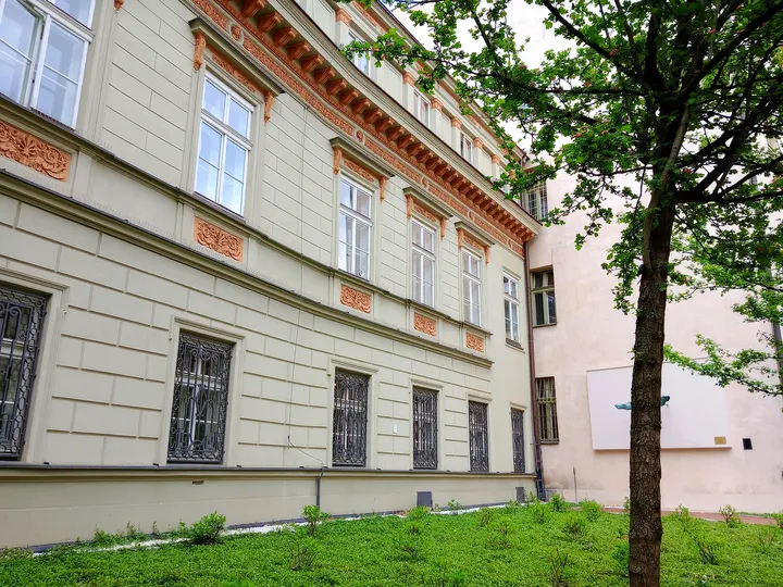 The street-side windows and low planting at Poselska Street