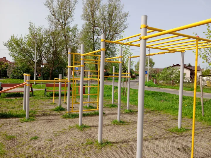 Wide view of the yellow equipment at Przylep outdoor exercise ground