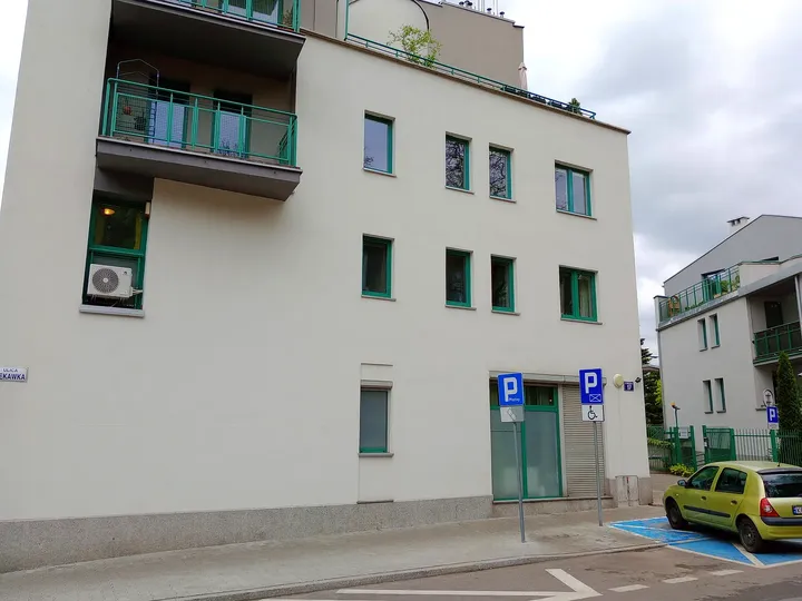A white building beside the hillside street at Rękawka hillside