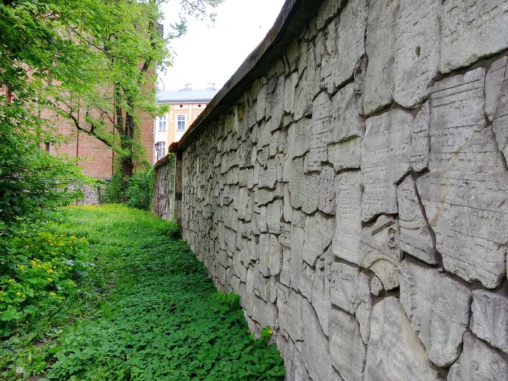 Inscribed fragments set into the wall at Remuh Cemetery