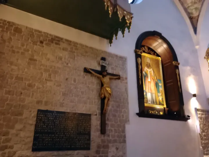 Crucifix and painting on the wall at Saint Adalbert’s Church, Kraków
