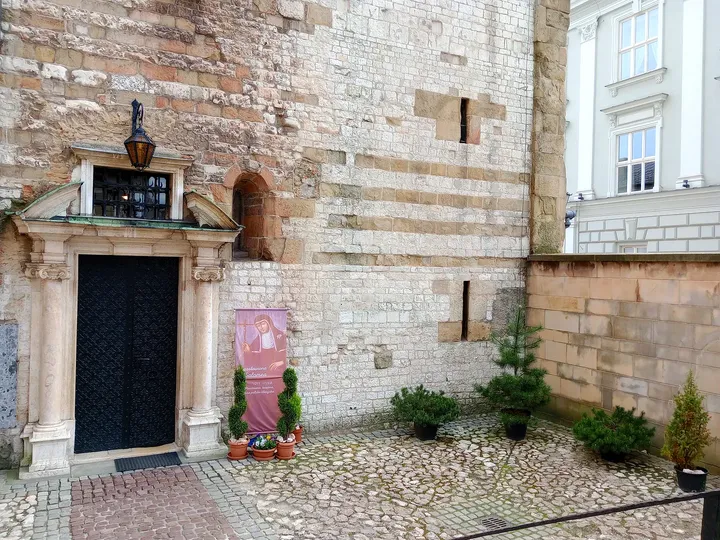 Lower stone wall and dark doorway at Saint Andrew’s Church, Kraków