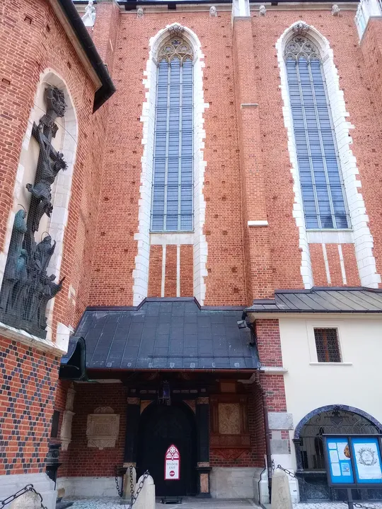 The brick façade and tall windows at Saint Barbara’s Church, Kraków