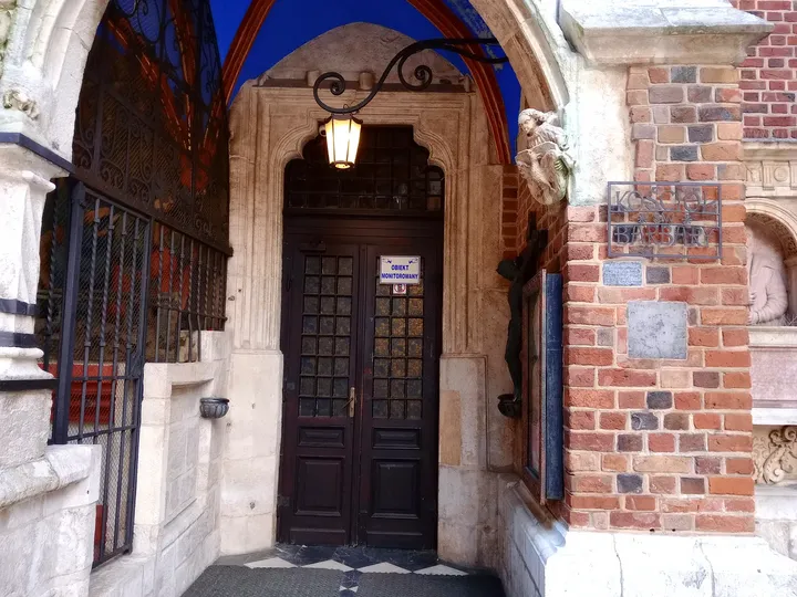 The open doorway beneath its stone arch at Saint Barbara’s Church, Kraków