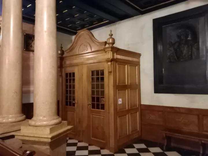 A doorway beside a memorial plaque at Saint Barbara’s Church, Kraków