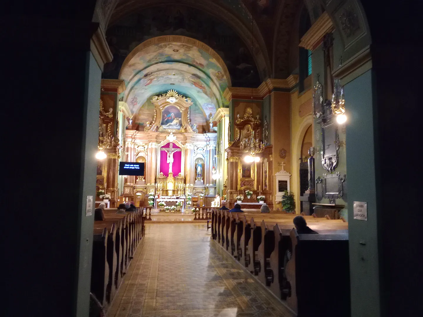 Lit altar at the end of the nave at Saint Casimir’s Church, Kraków