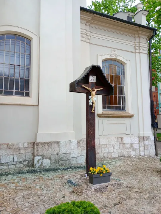 Timber cross against the pale wall at Saint Florian’s Church, Kraków