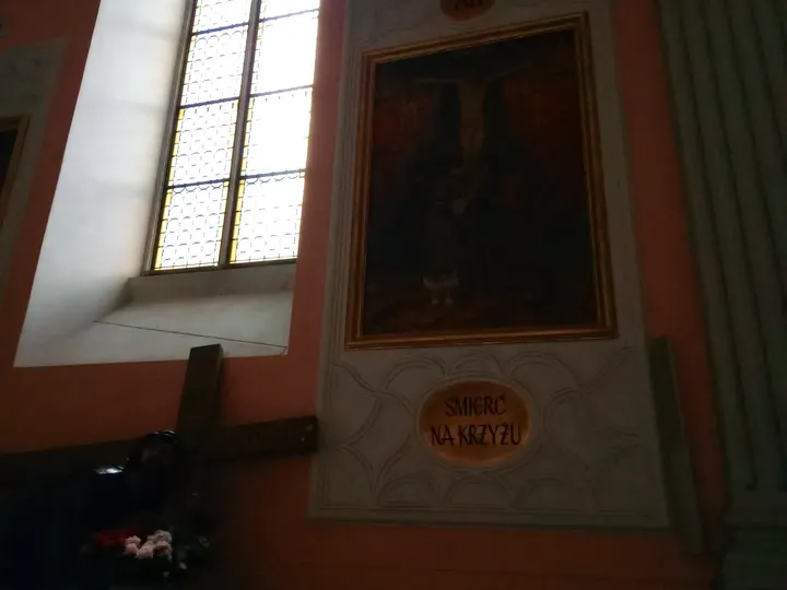 A painting beside a high window at Saint Francis of Assisi Basilica, Kraków