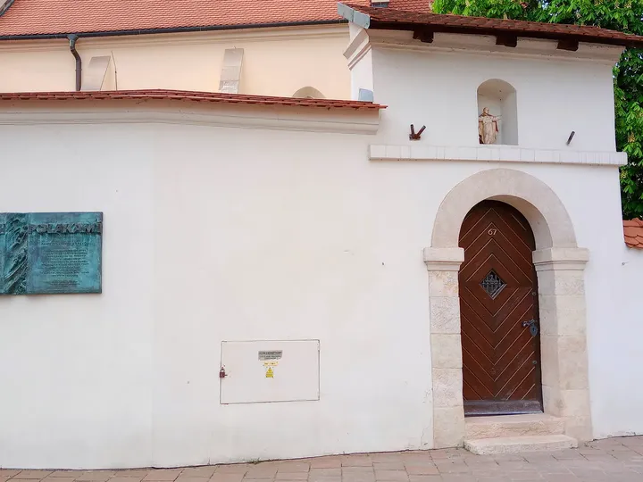 The pale wall and timber cross at Saint Giles’ Church, Kraków