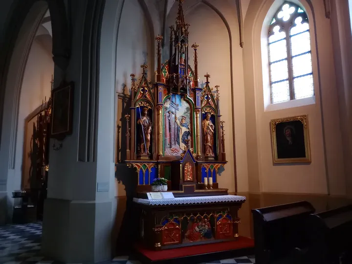 A side altar beside a tall window at Saint Joseph’s Church, Podgórze