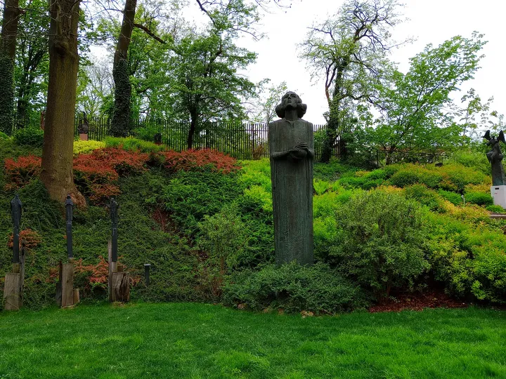 A garden path beneath spring planting at Saint Joseph’s Church, Podgórze
