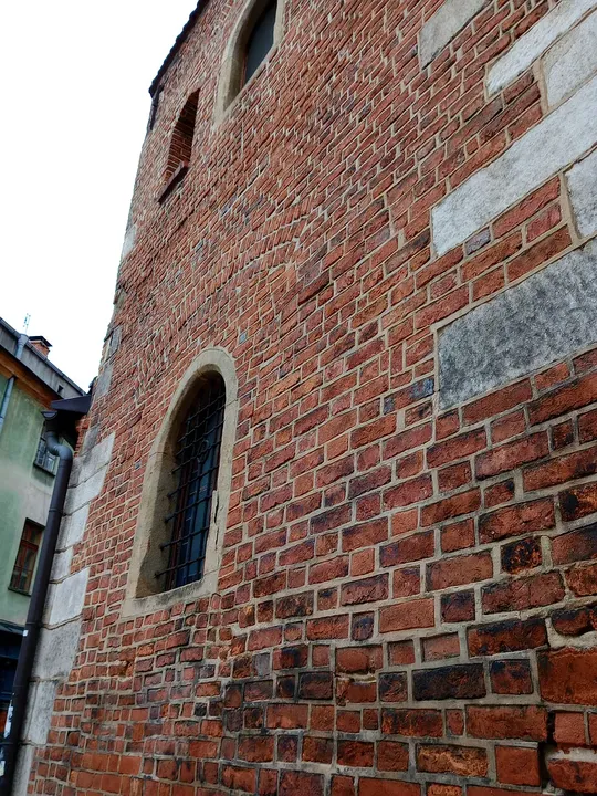 Small window in the brick masonry at Saint Mark’s Church, Kraków