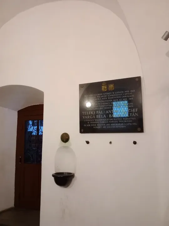 Pale interior wall and framed pictures at Saint Mark’s Church, Kraków
