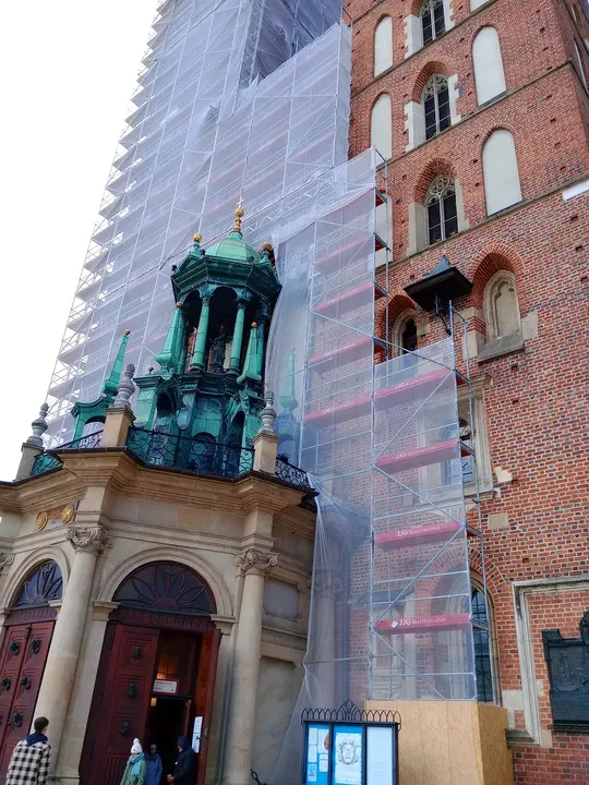 The stone porch beside the brick tower at Saint Mary’s Basilica, Kraków
