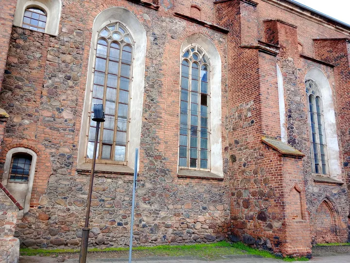 Tall windows in the brick side wall at Saints Peter and Paul Church, Żagań