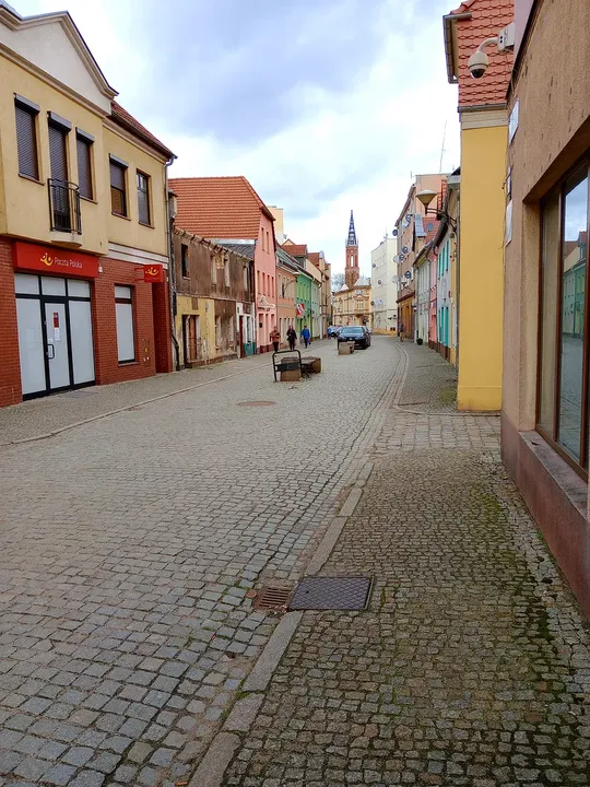 Townhouses beside the paved approach at Słowiański Square, Żagań