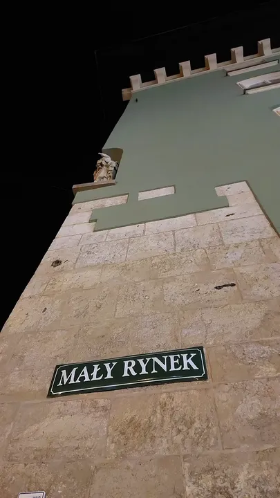 The Mały Rynek street name on an old wall at Small Market Square, Kraków