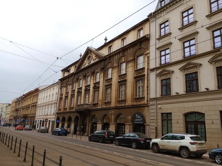 Long yellow frontage beside the roadway at Starowiślna Street