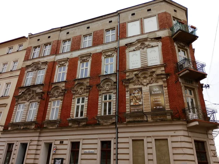 Red and pale corner building at Starowiślna Street