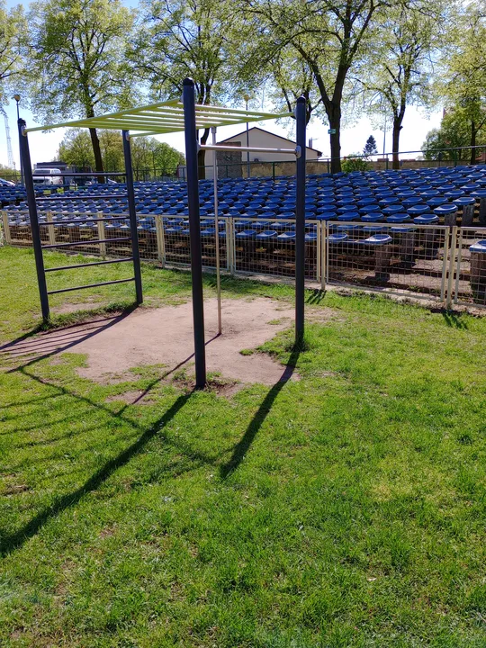 Workout bars near the spectator seats at Sulechowska stadium outdoor exercise ground