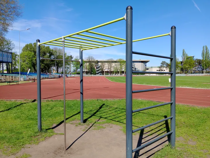 Bars beside the red running track at Sulechowska stadium outdoor exercise ground