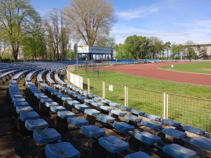 Spectator seats beside the grass at Sulechowska stadium outdoor exercise ground