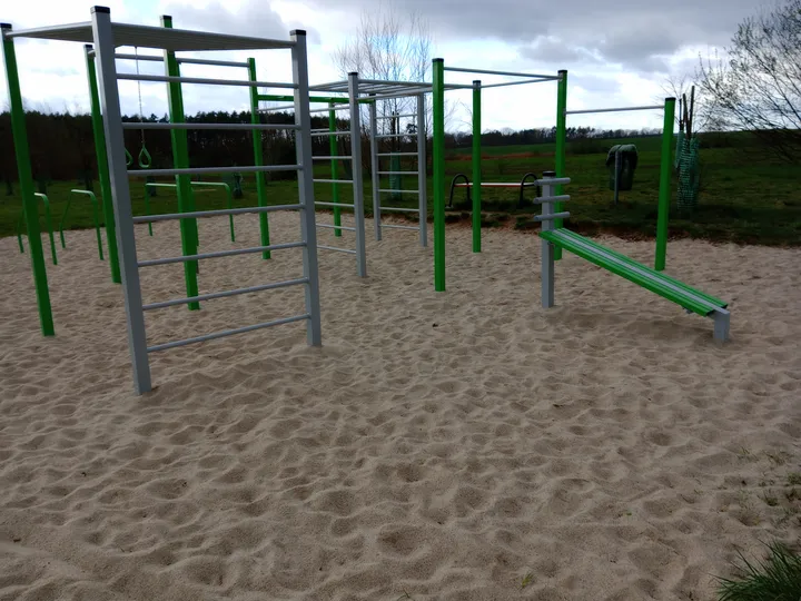 Green bars over the sandy surface at Świdnica outdoor exercise ground