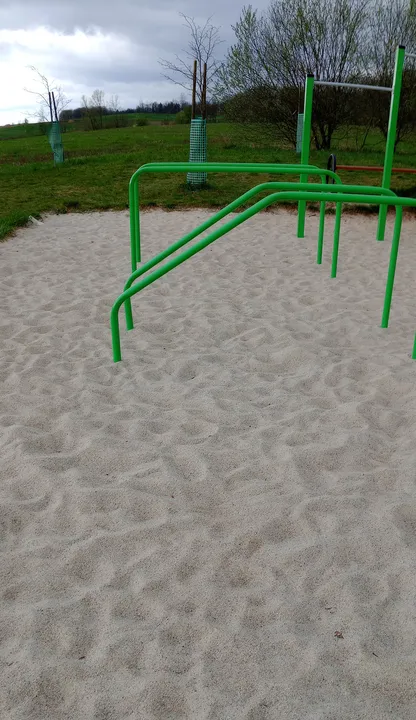 Workout stations beneath the grey sky at Świdnica outdoor exercise ground