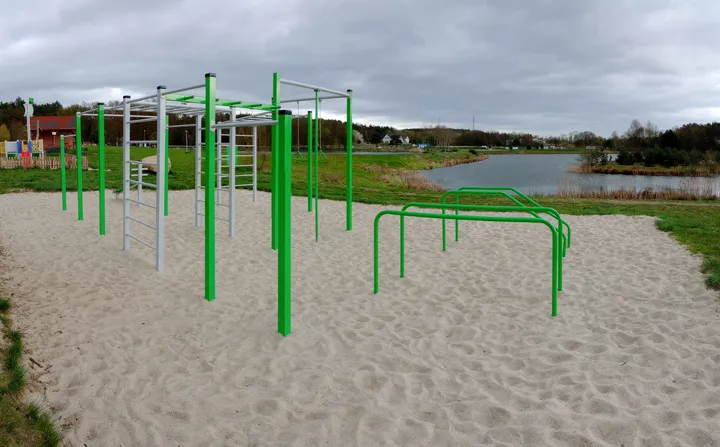 Green bars along the sandy ground at Świdnica outdoor exercise ground