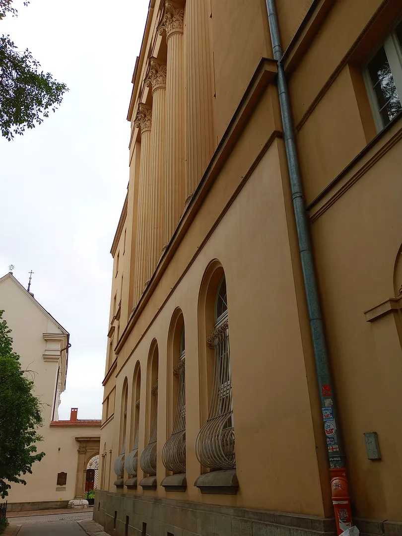 Pale church wall beside the path at Świętego Marka Street
