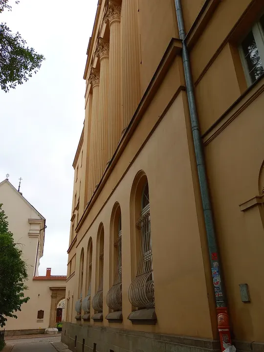 Pale church wall beside the path at Świętego Marka Street