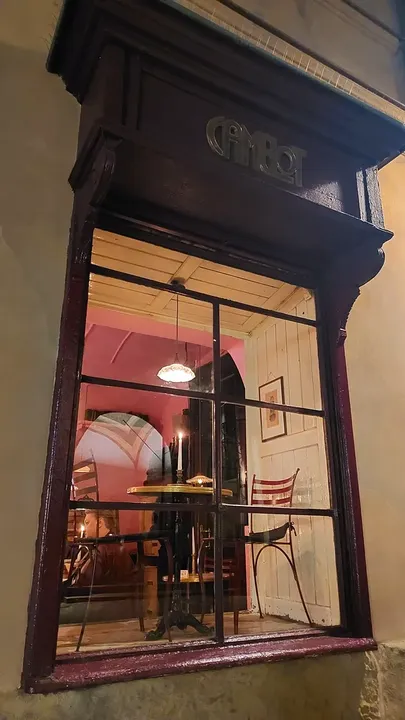 Red window frontage at night at Świętego Tomasza Street
