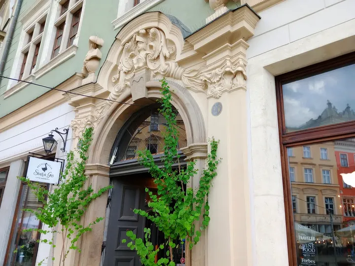 Carved stonework above the entrance at Szara Gęś