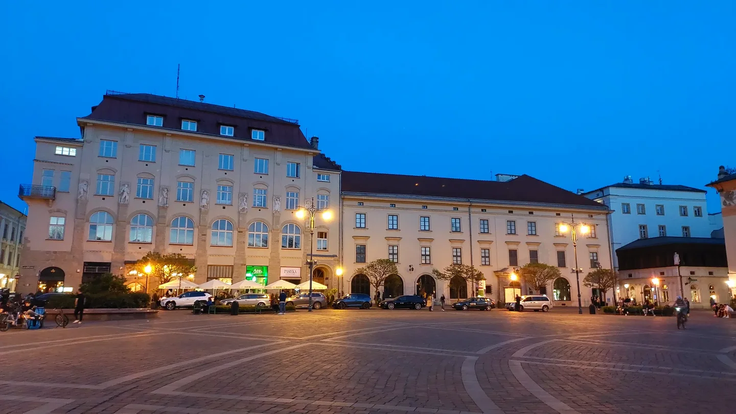 The square’s open paving after dark at Szczepański Square