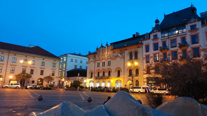 The illuminated buildings around the square at Szczepański Square
