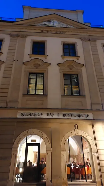 An illuminated entrance at the square’s edge at Szczepański Square