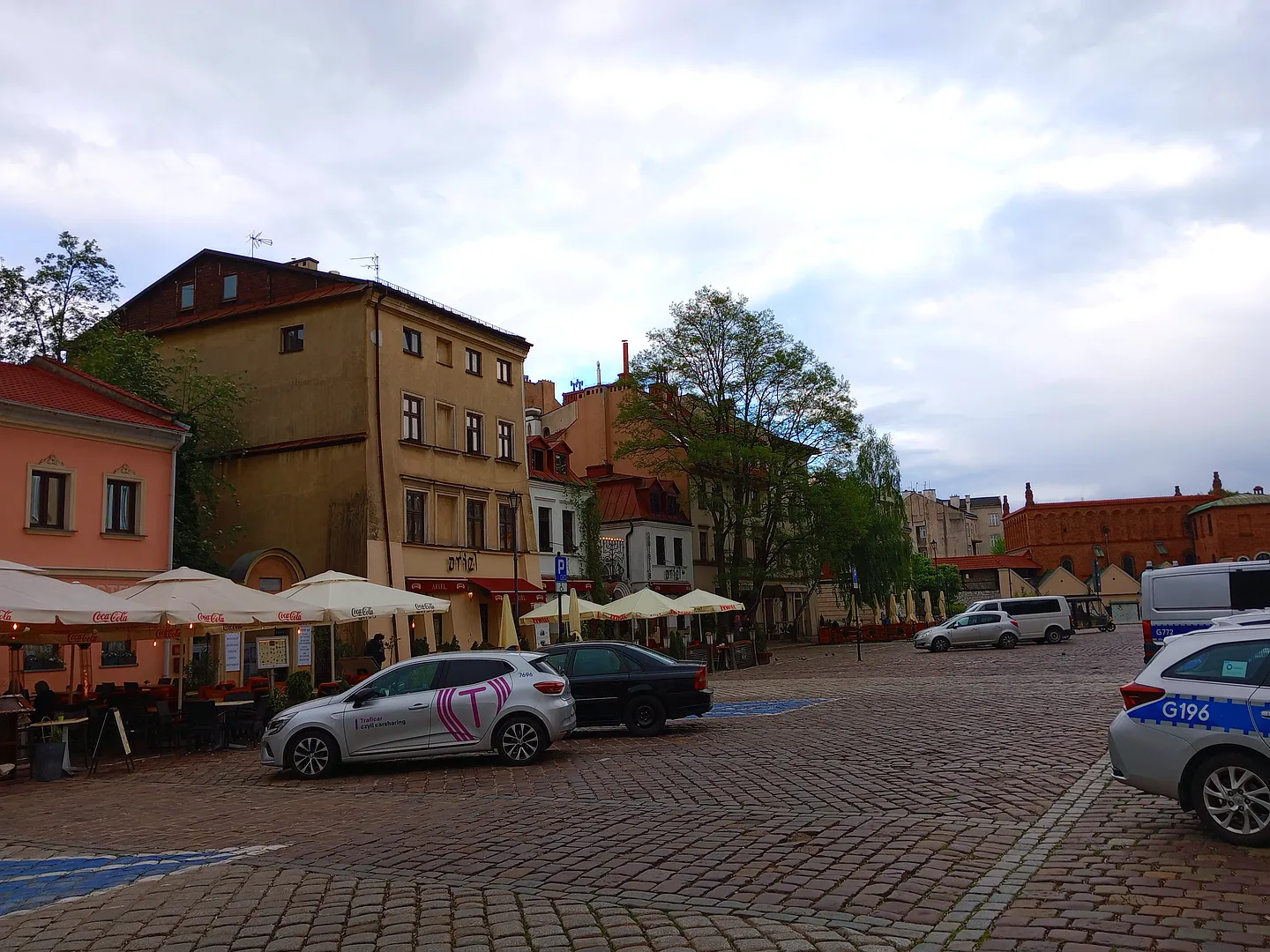 Open paved space facing the older buildings at Szeroka Street